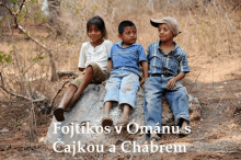 three children are sitting on a rock with the words fojtikos v omanu s on the bottom