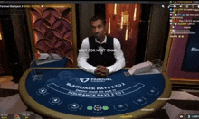 a man sitting at a blackjack table with the words wait for next game visible