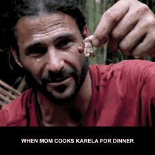 a man in a red shirt is holding a piece of meat in his hand with the words when mom cooks karela for dinner below him