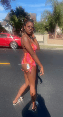 a woman in a bikini is walking down a street