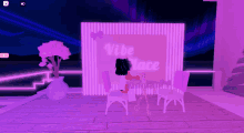 a girl sitting at a table in front of a sign that says vibe place