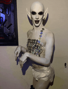 a statue of a woman with a white body painted to look like an alien