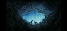 a painting of two horses in a cave with a blue sky in the background