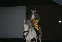 a man in a costume is riding a white horse