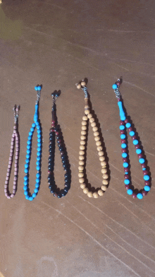 five different colored beads are lined up in a row on a table