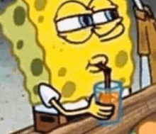 spongebob is drinking orange juice through a straw .