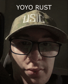 a man wearing glasses and a hat with the word usc on it