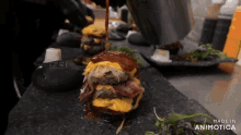 a person is pouring sauce on a hamburger that is being made in animatica