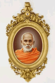 a picture of a man in an orange robe is in a gold frame with foreign writing