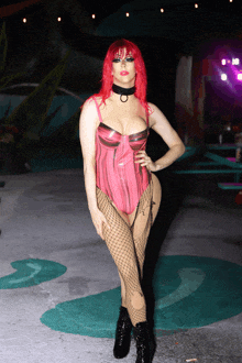 a woman with red hair is wearing a pink bodysuit and fishnet tights