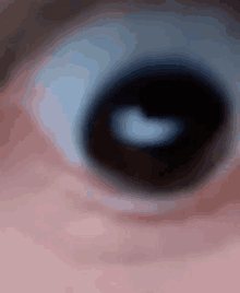 a close up of a person 's eye with a white circle in the middle