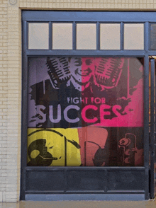 a window with a poster that says " fight for success "