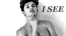 a black and white photo of a shirtless man with the words `` i see '' above him .