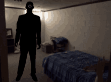 a silhouette of a man with an o on his head standing in a bedroom