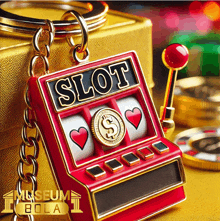 a red slot machine keychain with hearts and a dollar sign on it