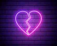 it is a neon sign of a broken heart on a brick wall .