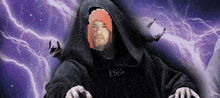 a man in a hooded robe has a pixelated face on his head