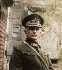 a man with a mustache wearing a military uniform and hat