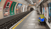 a frog sits on a bench in a subway station