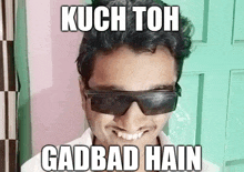 a man wearing sunglasses with the words kuch toh gadbad hain above him