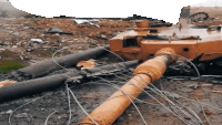 a destroyed tank is laying on the ground with a bunch of wires coming out of it