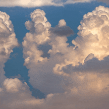 a blue sky with white clouds that look like the letter v