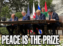 a group of men sitting at a table with the words peace is the prize below them