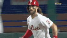 a philadelphia phillies baseball player is running towards the base