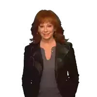 a woman with red hair wearing a black jacket