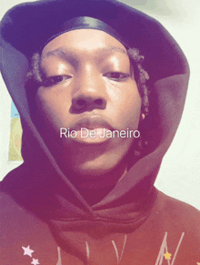 a person wearing a hoodie with the words rio de janeiro on the bottom right