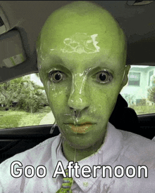 a man with a green face has goo coming out of his nose and mouth