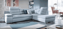 a living room with a sectional couch and a chair