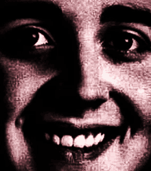 a close up of a woman 's face with a smile on her face