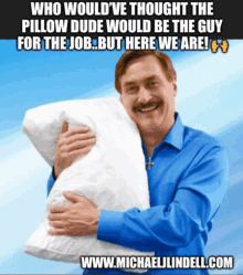 a man in a blue shirt is hugging a white pillow with the website www.michaellindell.com at the bottom of the picture