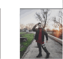 a young man wearing a red shirt and black jacket stands on a dirt road