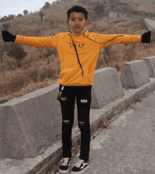 a young boy wearing a yellow ufo sweatshirt