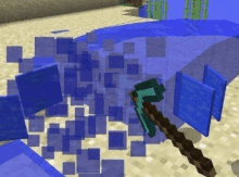 a minecraft game with a pickaxe and a bunch of blue cubes floating in the air .