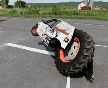 a white car is sitting on top of a large tire