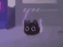 a black cat with glowing eyes is sitting on a purple surface in a room .