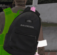 a black balenciaga backpack is being worn by a man