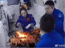 a man and a woman are cooking food on a grill