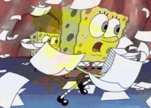 spongebob squarepants is holding a piece of paper in his hand while standing next to a pile of papers .