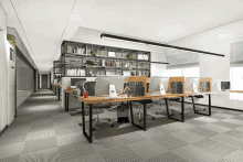 a row of cubicles in an office with computer monitors on them