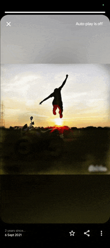 a picture of a person jumping in the air with a sunset in the background