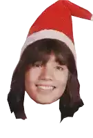 a woman wearing a santa hat is smiling and looking at the camera