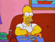 homer simpson is sitting on a couch with a can of duff beer and knitting .