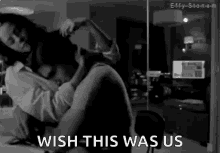 a black and white photo of a man and woman kissing with the words `` wish this was us '' written on the bottom .