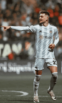 a soccer player wearing a white shirt with the word rain on it