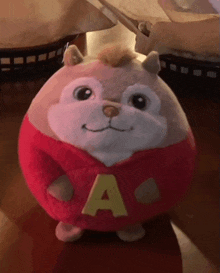 a stuffed animal with the letter a on it 's shirt