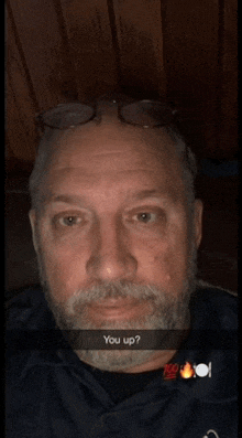 a man with glasses and a beard has a snap that says " you up "